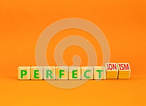 Perfectionism symbol. Concept words Perfect or Perfectionism beautiful wooden blocks. Beautiful orange table orange background.