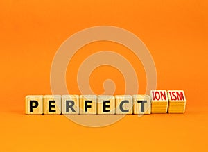 Perfectionism symbol. Concept words Perfect or Perfectionism beautiful wooden blocks. Beautiful orange table orange background.