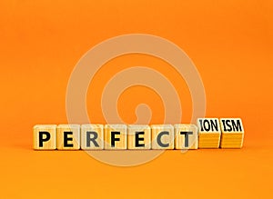 Perfectionism symbol. Concept words Perfect or Perfectionism beautiful wooden blocks. Beautiful orange table orange background.