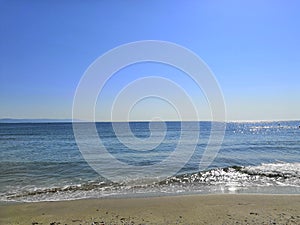A perfectly flat horizon of the calm sea without waves and clear skies, the background of natural tranquillity. summer trip