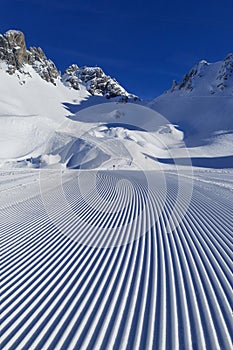 Perfectly groomed empty ski piste