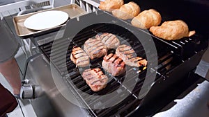 Perfectly Seasoned Pork Chops Sizzling on an Outdoor Gas Grill