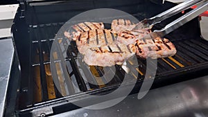 Perfectly Seasoned Pork Chops Sizzling on an Outdoor Gas Grill