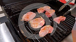 Perfectly Seasoned Pork Chops Sizzling on an Outdoor Gas Grill