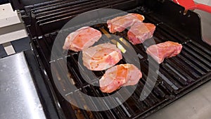 Perfectly Seasoned Pork Chops Sizzling on an Outdoor Gas Grill