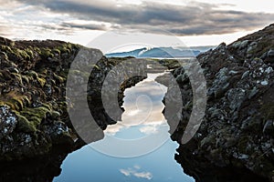 Perfectly still water on a lake in where the land splits, Iceland