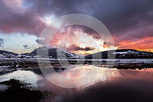 Perfectly symmetric clouds and hills reflections on Colfiorito Umbria swamp at dusk