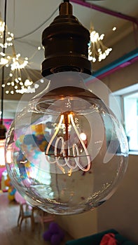 Perfectly transparent light bulb with heated electrical coil inside it