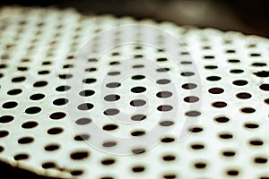 Perforated aluminium sheet of metal texture. Vinatge urface with depth of field, abstract industrial mesh old background