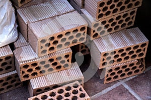 Perforated clay bricks in a pile