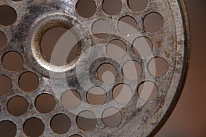 Perforated disk used as part of an old meat grinder