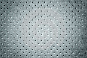 Perforated light blue leather texture background, closeup. Gray backdrop from wrinkle skin