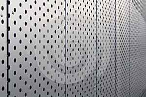 Perforated metal panel. Facing of buildings and structures perforated metal siding. Horizontal.