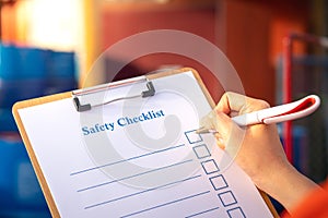Perform checking of safety checklist with chemical storage background.