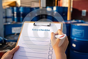 Perform checking of safety checklist with chemical storage background.