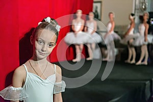 Performance of a children`s private ballet school. Portrait of little girl.