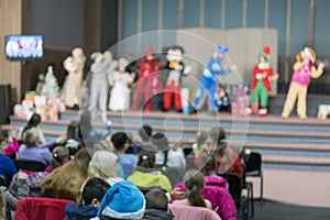 Performance for children on stage. Children on stage perform in front of parents. image of blur kid's show on stage at school ,