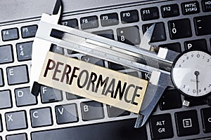 Performance measurement or level with caliper on computer notebook