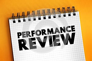 Performance Review - formal assessment in which a manager evaluates an employee`s work performance, text concept on notepad
