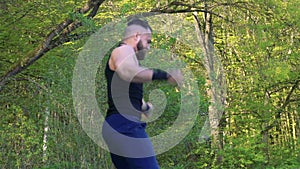 The performance of Wing Chun by master on forest background. Slowly