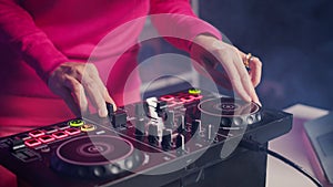 Performer creating unique techno sound using mixer console