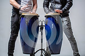 Performers playing bongo drums. Close up of musician hand playing bongos drums. Afro-Cuba, rum, drummer, fingers, hand