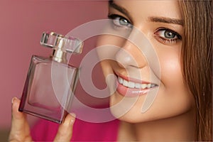 Perfume, beauty product and cosmetics model face portrait on pink background, beautiful woman holding fragrance bottle