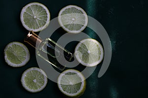 A perfume bottle at the centre of roundly arranged slices of lemon