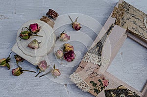 Perfume bottle, dry roses, romantic photo frame in vintage style