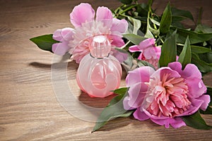 Perfume bottle and flowers on old boards