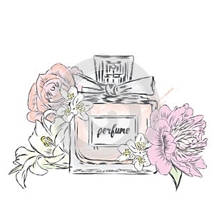 Perfume bottle and flowers. photo