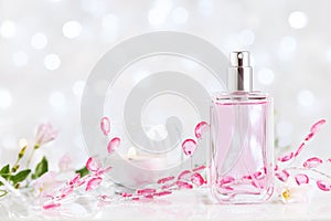 Perfume bottle with fresh flower fragrance. Beauty and perfumery background. photo