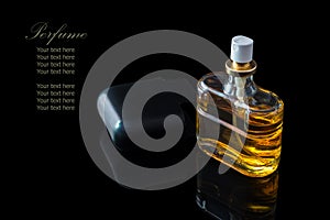 Perfume bottle isolated on black background with reflexion.