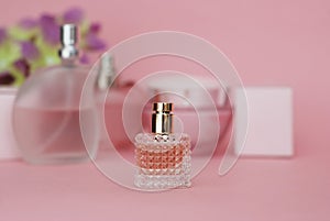 Perfume Bottle on light Pink background. Perfumery, cosmetics, fragrance collection.