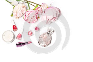 Perfume bottle, nail polish, lipstick. Fashion woman still life. Pop female things with flowers on white background