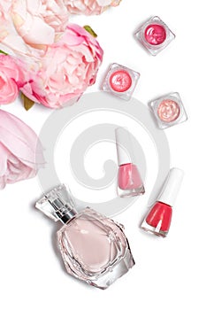 Perfume bottle, nail polish, lipstick. Fashion woman still life. Pop female things with flowers on white background.