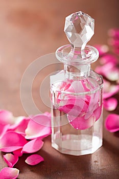 Perfume bottle and pink rose flowers. spa aromatherapy