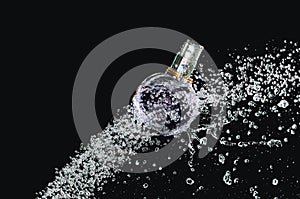 Perfume bottle on water photo