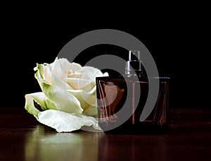 Perfume bottle with white rose