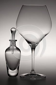 A perfume bottle and a wine glass