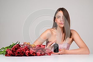 Perfume bottle. Woman with spray aroma perfume. Woman holding a perfumes bottle. Beautiful girl using perfume. Woman