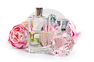 Perfume bottles with flowers on light background. Perfumery, cosmetics, fragrance collection