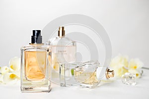 Perfume bottles and flowers on table