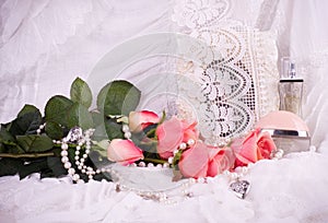 Perfume bottles, pink roses and frame