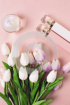 Perfume bottles surrounded by flowers