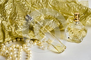 perfume bottles on yellow-white background with pearls