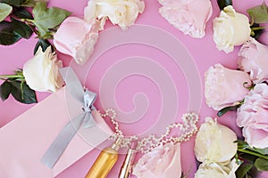 Perfume, gift, pearls, gentle roses on a pink background.