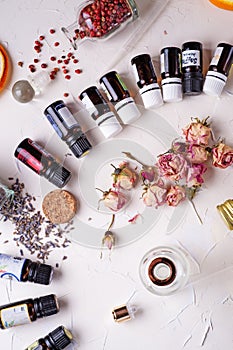 Perfume ingridients around white background. Perfumer, beauty and trendy concept.  flat lay