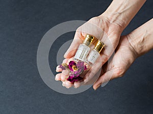 Perfume in a mini bottle on the black background