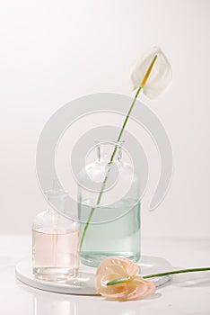 Perfume oils concept. Laboratory glassware with infused floral water on table